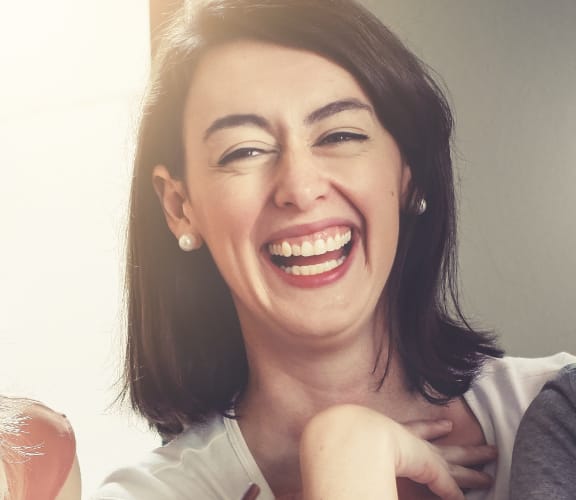 Group of three woman laughing with each other